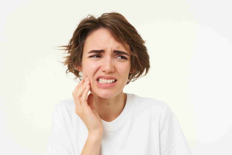 A person sitting calmly in a well-lit room while a gloved hand gently examines their tooth with dental tools, representing a safe and painless tooth extraction at home.